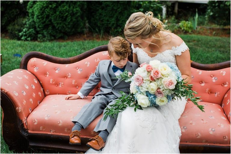 Bride talks to ring bearer in adorable photo at Abble Holmes Estate wedding