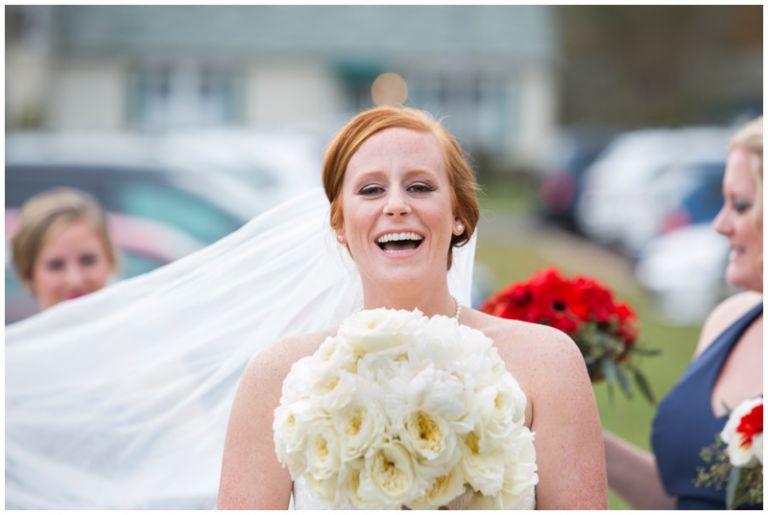 Country Club Wedding Bride laughing with primrose bouquet