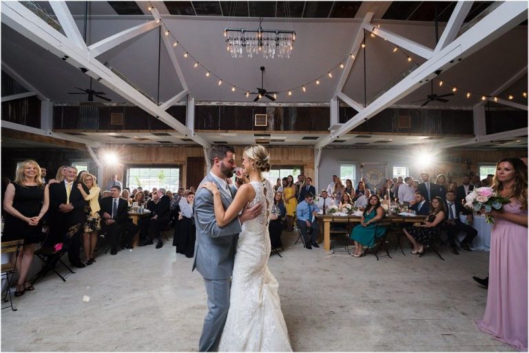 Bride and groom dance at rustic wedding at Everly at railroad wedding
