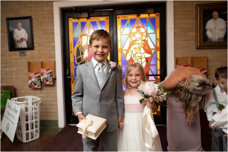 Flower girl and ring bearer getting ready to walk down aisle at Longport church