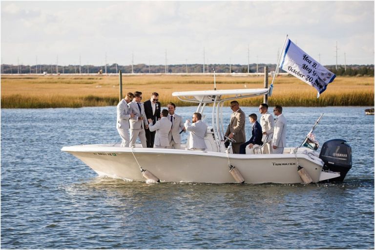 Groomsmen arrive at wedding ceremony in boat