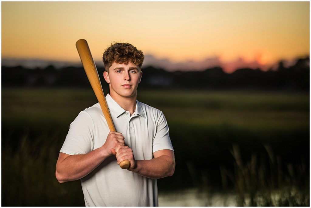 senior portrait with high schooler holding baseball bat