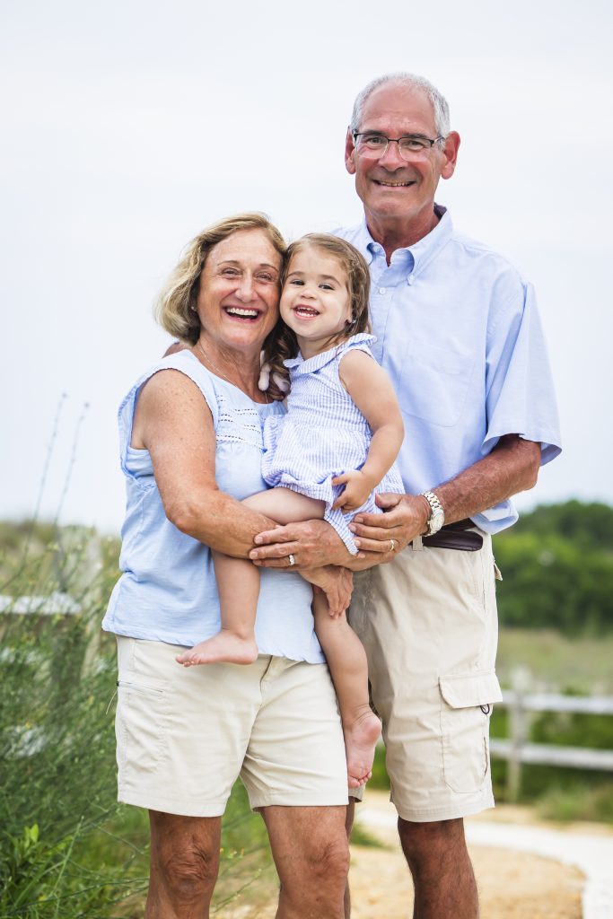grandparents with grandaughter being photographed by Dan