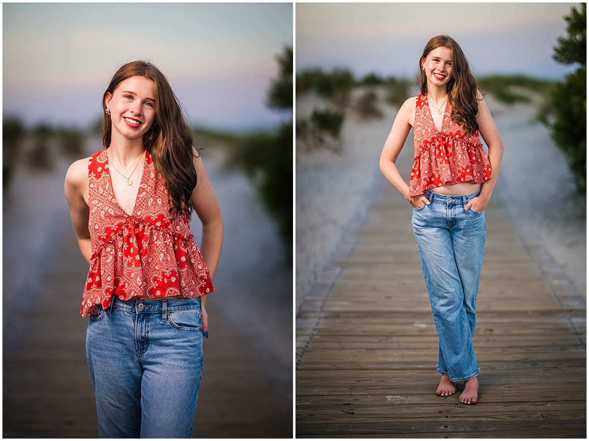 high school senior on beach walkway in jeans and red shirt