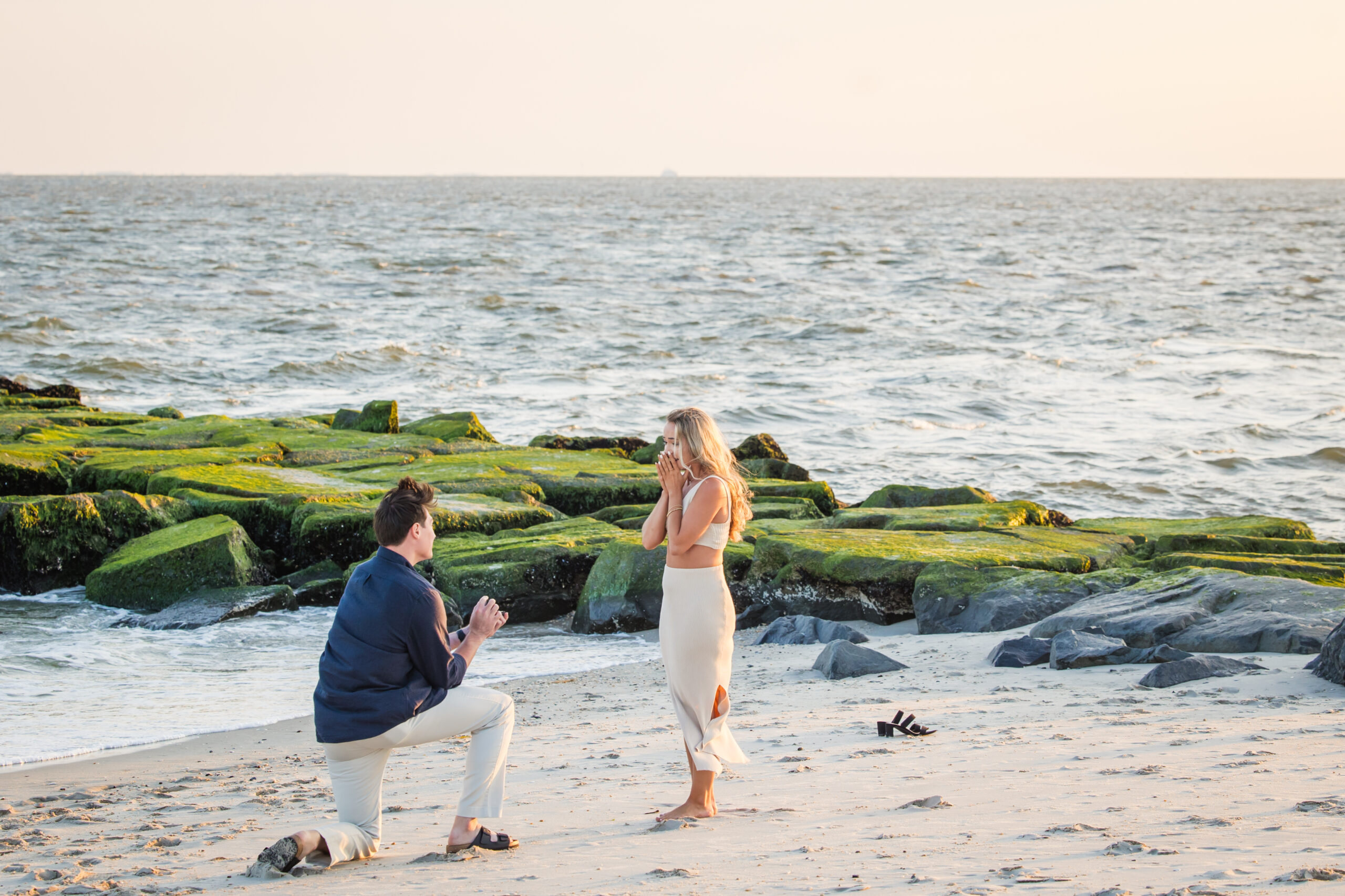 man on one knee proposing on beach in cape may, nj