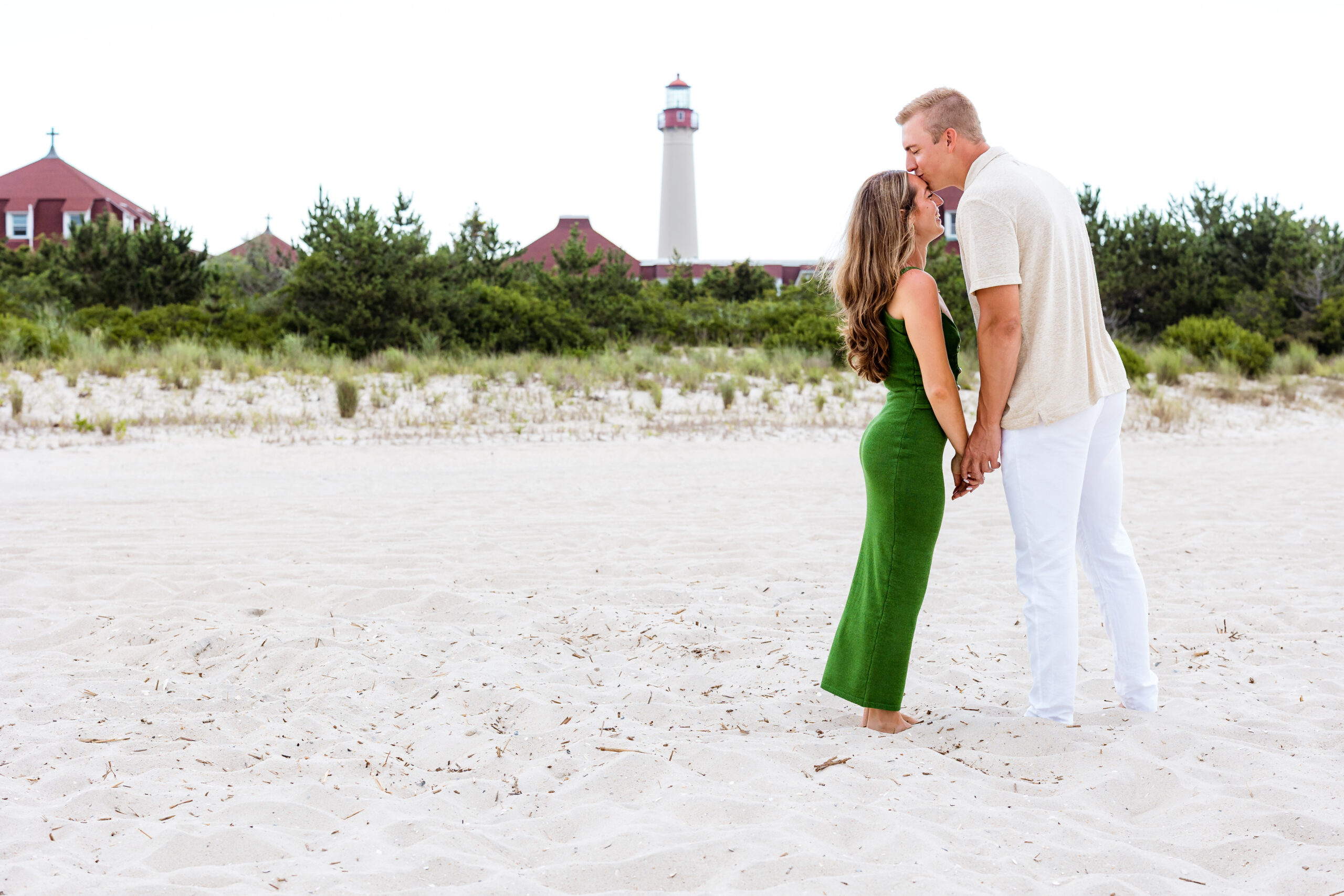 couple photo shoot with cape may lighthouse in background