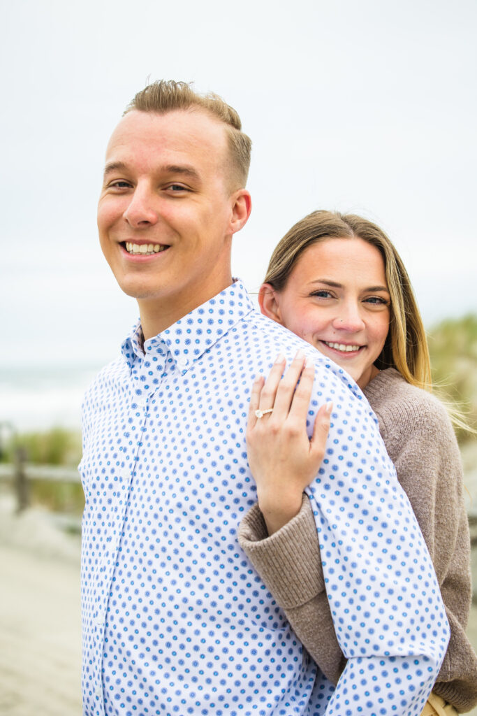 couple showing off engagement ring
